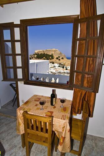 a table and a window in a room with a view at Lindos Panorama in Líndos