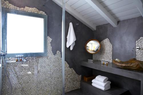 a bathroom with a shower and a mirror at Braunis Horio Villas in Asos