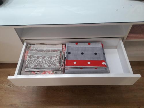 a white drawer with several pillows in it at Black Sea Apartament in Batumi