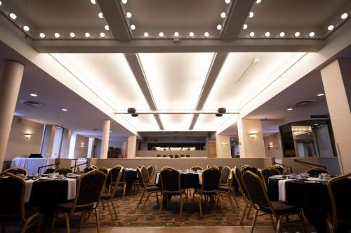 a banquet hall with tables and chairs and lights at Prince Arthur Waterfront Hotel & Suites in Thunder Bay