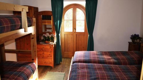 a bedroom with two bunk beds and a window at Rifugio Ghiacciaio dei Forni in Valfurva