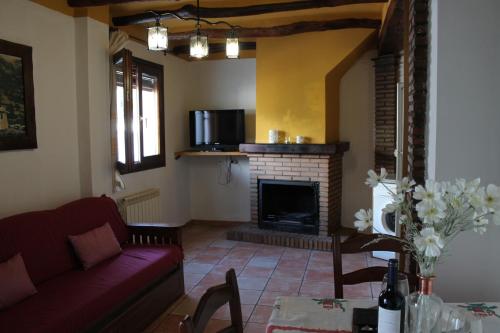 a living room with a couch and a fireplace at La Tila in Capileira