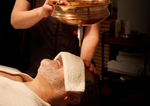 a man getting his face washed with a hand mixer at YO1 Longevity & Health Resorts, Catskills in Monticello