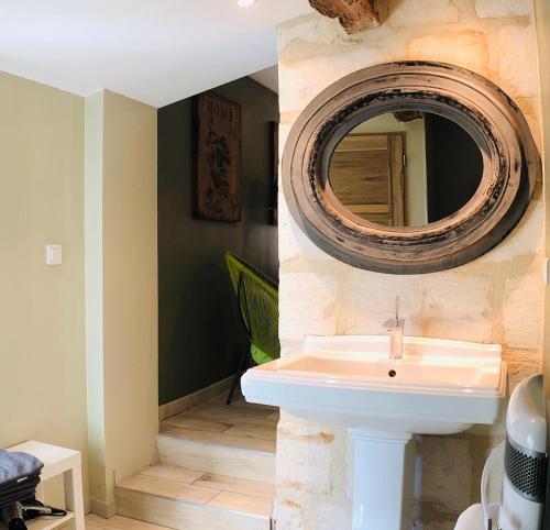 a bathroom with a sink and a mirror on the wall at Mas Guiraud, le Coquet in Beaucaire
