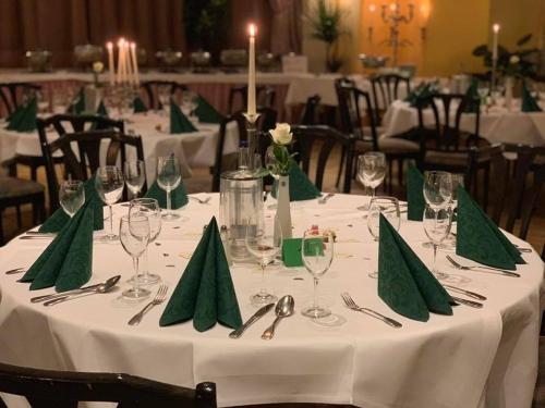 a table with green napkins and wine glasses on it at Sohre in Hamburg