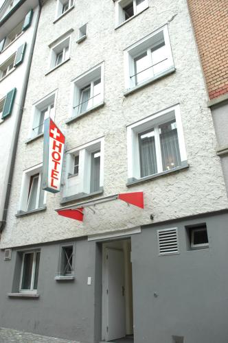 a building with a sign on the side of it at Hotel Weisses Kreuz in St. Gallen
