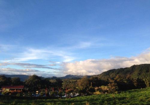 a view of a field with mountains in the background at Estancia San Antonio in Guasca