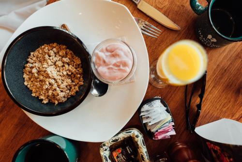 a table with a bowl of food on a plate at High Peaks Resort in Lake Placid