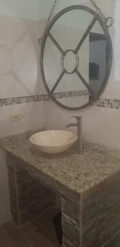 a bathroom with a sink and a mirror on a counter at Spanish Dream Hotel in Kingston
