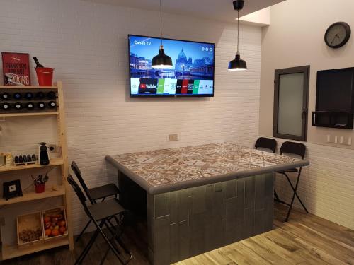 a room with a bar with a tv on the wall at VENTIMIGLIA SUITE & WINE in Catania