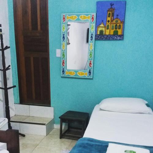 a room with two beds and a mirror on the wall at SunriseBelaVista Pousada e Flats in Paraty