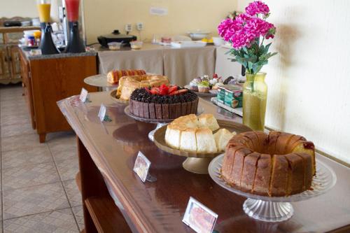 a buffet with cakes and pies on a table at Planet Dunas Residence in Aquiraz