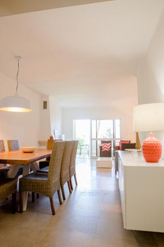 a kitchen and dining room with a table and chairs at Loving Tróia in Troia