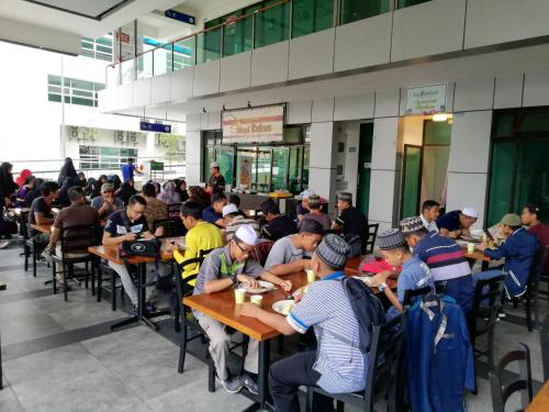 a group of people sitting at tables eating food at Shah Suites Vista Alam in Shah Alam