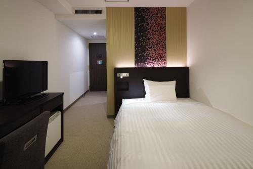 Letto o letti in una camera di Hotel Mets Nagaoka