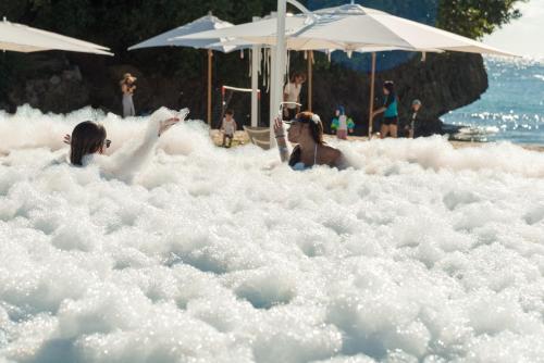 two women swimming in an foam bathtub on a beach at Crimson Resort and Spa Boracay in Boracay