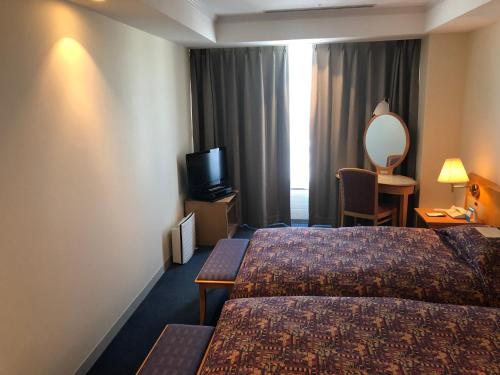Postel nebo postele na pokoji v ubytování Kushiro Prince Hotel