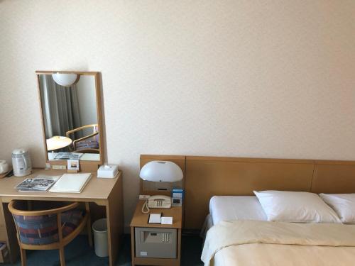 Postel nebo postele na pokoji v ubytování Kushiro Prince Hotel