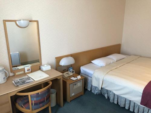 Postel nebo postele na pokoji v ubytování Kushiro Prince Hotel