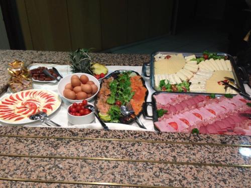 a table topped with lots of different types of food at Hôtel Restaurant de L'Europort in Saint-Avold