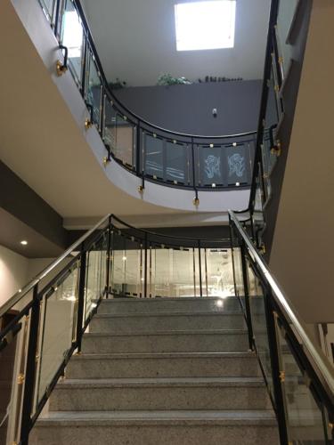 a stairway in a building with a glass floor at Hôtel Restaurant de L'Europort in Saint-Avold
