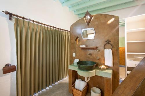a bathroom with a sink and a shower at Casa Abuelita: An exquisite, historic La Paz home in La Paz