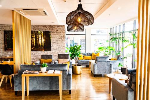 a living room with couches and a table at Porters Boutique Hotel in Havelock North