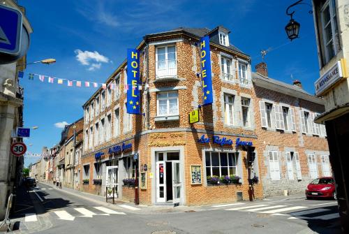 a tall brick building with a sign on it at Les Reflets Jaunes in Givet