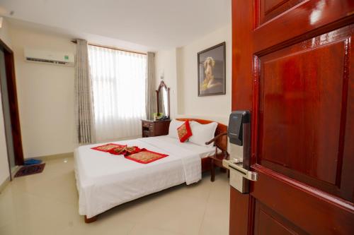 מיטה או מיטות בחדר ב-Nguyen Ha Hotel