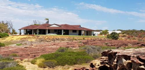 a small house with a view of the mountains at Kalbarri Red Bluff Tourist Park in Kalbarri