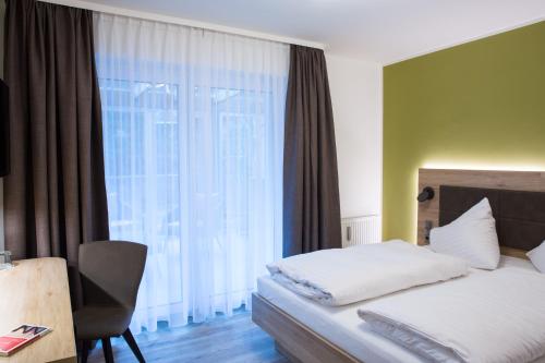 a hotel room with a bed and a window at Gästehaus Hotel Wilms in Cologne