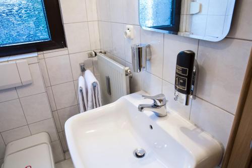 a bathroom with a sink and a toilet at Gästehaus Hotel Wilms in Cologne
