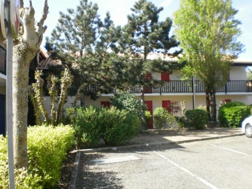 a parking lot in front of a building at LES OCEANIDES in Brétignolles-sur-Mer