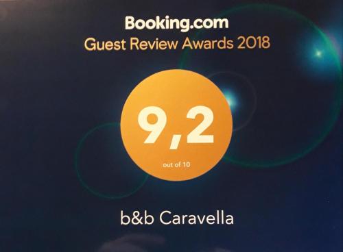a sign that reads guest review awards with a yellow circle at b&b Caravella in Mezzojuso