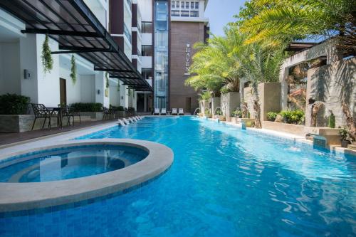 a swimming pool in the middle of a building at Boracay Haven Suites in Boracay