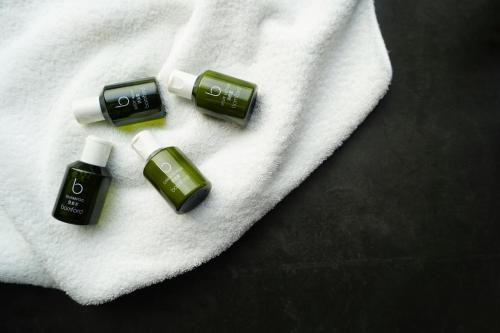 three bottles of essential oils on a white towel at The Temple House in Chengdu