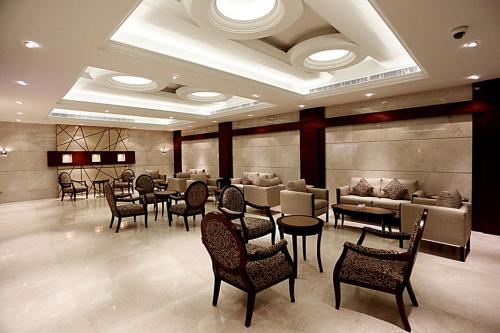 a restaurant with chairs and tables in a room at أسوار للشقق المخدومة in Al Khobar