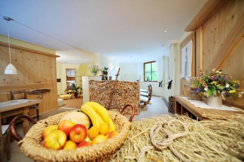 a basket of fruit on a table in a room at Pension Alwin in Lech am Arlberg
