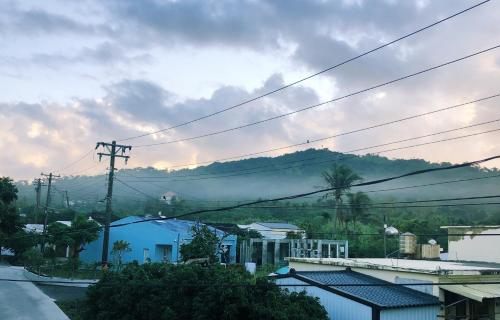 a view of a town with a mountain in the background at Mooning the Hill in Manzhou