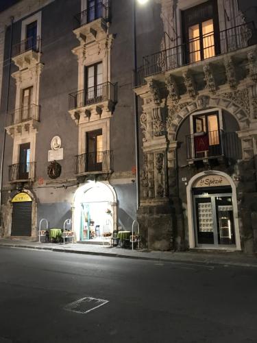 a building on the side of a street at night at PAPALI loft in Catania