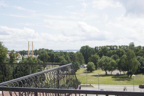 a view of a park from a balcony at Hotel Cesarski - Kaiserhof in Giżycko