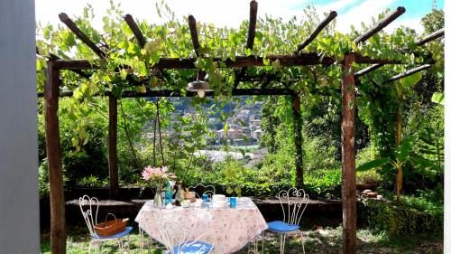 a table and chairs under a wooden pergola at The italian riviera in San Salvatore