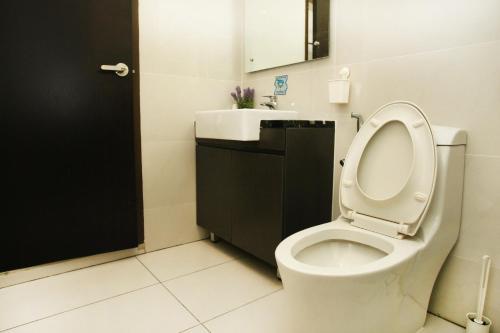 a bathroom with a toilet and a sink at Country garden danga bay ,bay point in Johor Bahru
