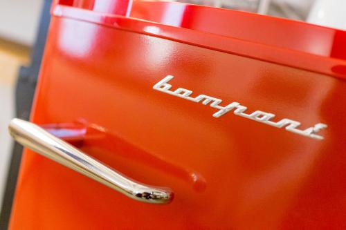 an orange suitcase with the word kitchen on it at Le Maestranze Deluxe Rooms in Sciacca