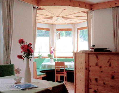 una stanza con un tavolo e un vaso con fiori di Haus Soldanella a Vent