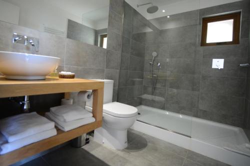 a bathroom with a sink and a toilet and a tub at Hotel Patagonia B&B in Punta Arenas