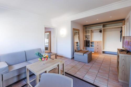 a living room with a couch and a table at Villa Favorita - Parkhotel Delta in Ascona