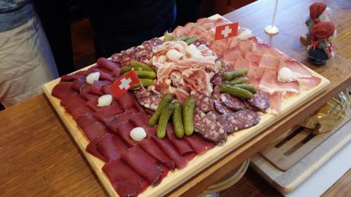 a tray of meats and vegetables on a table at Chalet le Grenier - Romantique et exclusif in Champéry