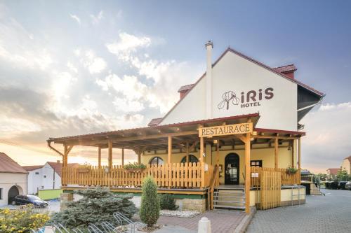 a restaurant with a sign on the front of it at Wellness Hotel IRIS in Pavlov