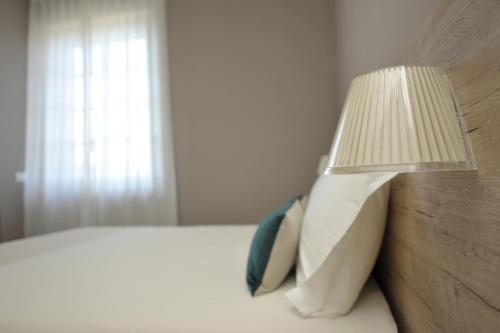 a bedroom with a bed with a lamp on it at Bergamo Inn 43 in Bergamo